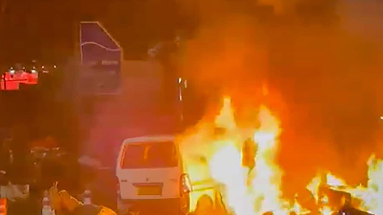 Flames rise after a blast occurred in a parked car near Red Fort, in New Delhi, Monday. PTI