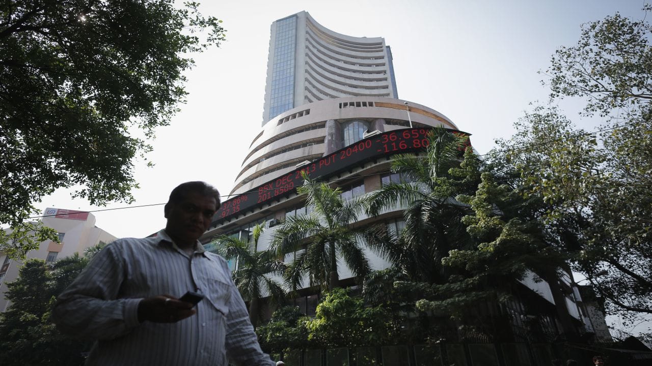 A man walks past the Bombay Stock Exchange (BSE) building in Mumbai December 5, 2013. The Indian rupee rose to a five-week high against the dollar and stocks jumped more than 2 percent to near record highs on Thursday as exit polls predicted a strong showing for the key opposition party in recent state elections. REUTERS/Danish Siddiqui (INDIA - Tags: BUSINESS) - GM1E9C51DBY01