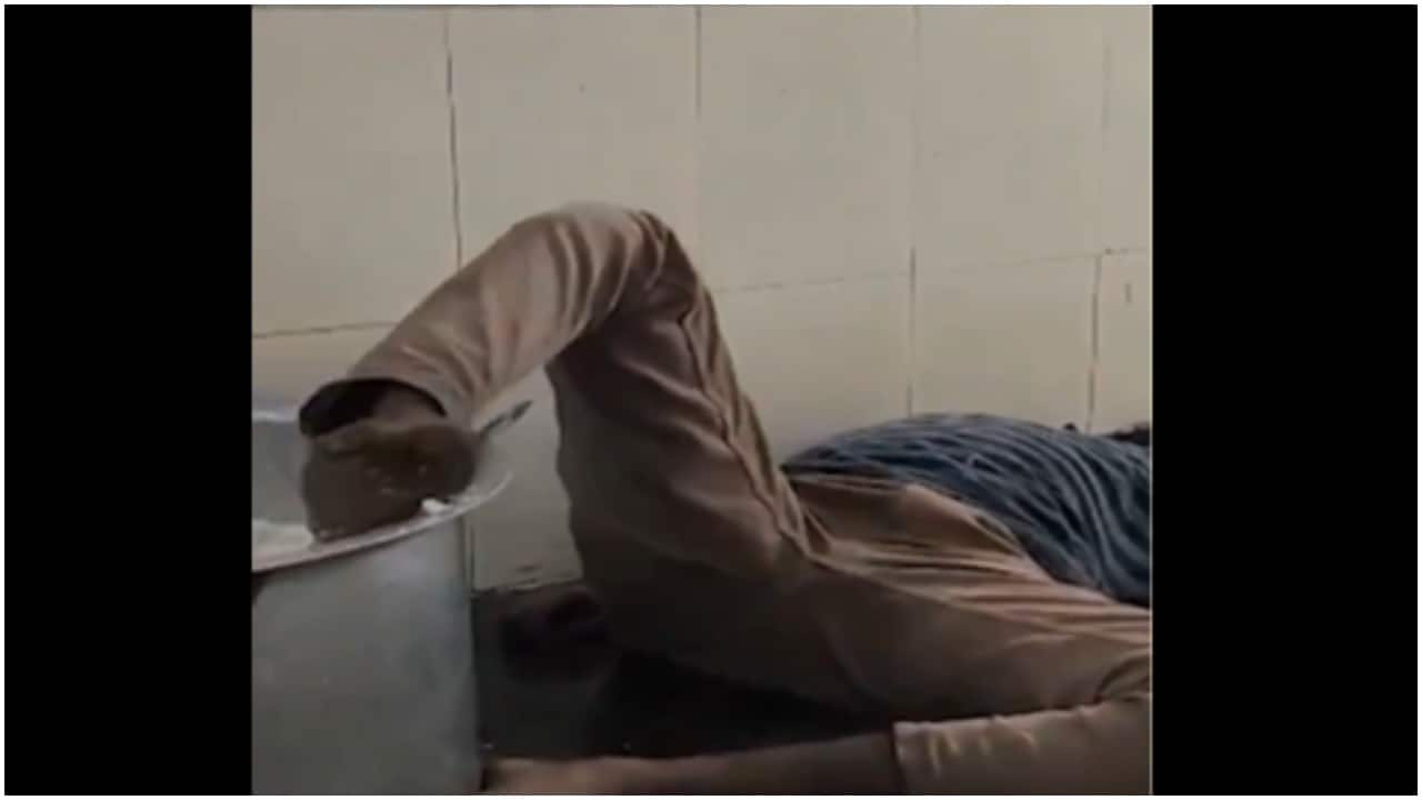 Drunk watchman filmed sleeping with leg inside cooked rice vessel by students of Telangana college. Video