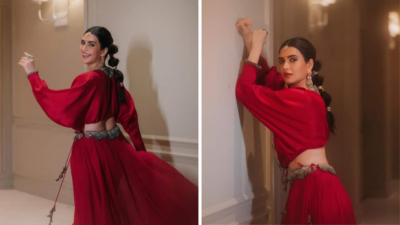 Karishma Tanna’s Hair Ties Karishma looks stylish as ever in a modern red ensemble styled with braid gotas. They look every bit chic and elevate her look flawlessly. Her jewellery looks equally alluring with a sleek maang tikka and earrings. (Image: Instagram)