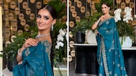 <strong>Beauty in a teal saree</strong><br />Manika looks breathtaking in this teal saree draped elegantly around her frame, paired with a matching blouse. Its beauty lies in the intricate traditional embroidery. Her styling with sparkling jewellery, including earrings, a necklace, and bangles, enhances the look.