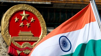 File photo of an Indian national flag flying next to the Chinese national emblem during a welcome ceremony for visiting Indian officials outside the Great Hall of the People in Beijing in 2013.