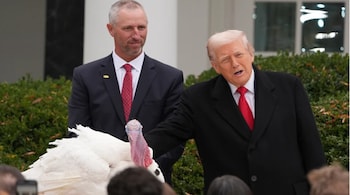 US President Donald Trump stands next to the national Thanksgiving turkey during a pardoning ceremony in the Rose Garden of the White House