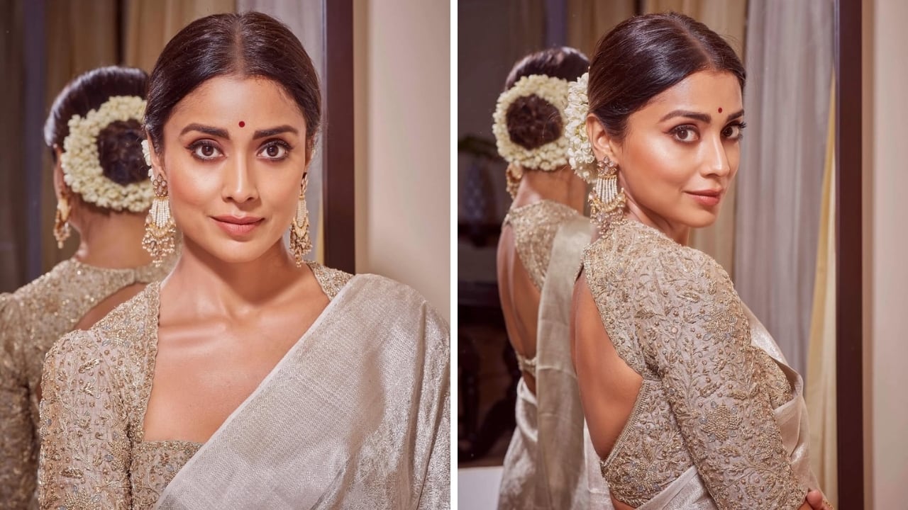Shriya Saran looks magical in a silver saree with a back keyhole blouse design and desi gajra