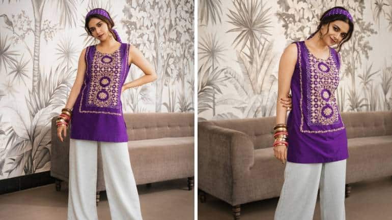 <strong>Boho fun in purple</strong><br />Drenched in the spirit of her character, she looked vibrant in a purple short kurti from Pink City by Sarika. It featured traditional embroidery and mirror work, and was complemented with wide-legged denim pants. The fun element came from the accessories: a retro polka-dot headscarf, a stack of bangles, and earrings, finished with brown shoes.