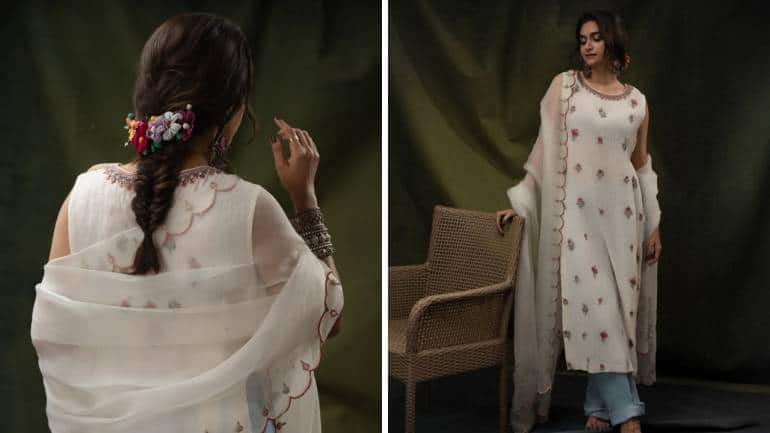 <strong>Subtle yet stunning desi style</strong><br />For another outing, Keerthy wore a subtle white kurta with delicate pink floral embroidery. The buttis were scattered across the fabric, and the long shirt was once again paired with straight-fit, rolled-up denim. Her antique silver jewellery tied the look together beautifully. What really stood out this time was her braid, decorated with a colourful accessory.
