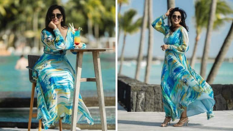 <strong>Chic in blue fit</strong><br />The actress looks happier than ever in a joyful blue printed dress, which looks stunning on her. For accessories, she is seen in high heels, a pair of stylish earrings, and trendy sunglasses. The backdrop is equally gorgeous.