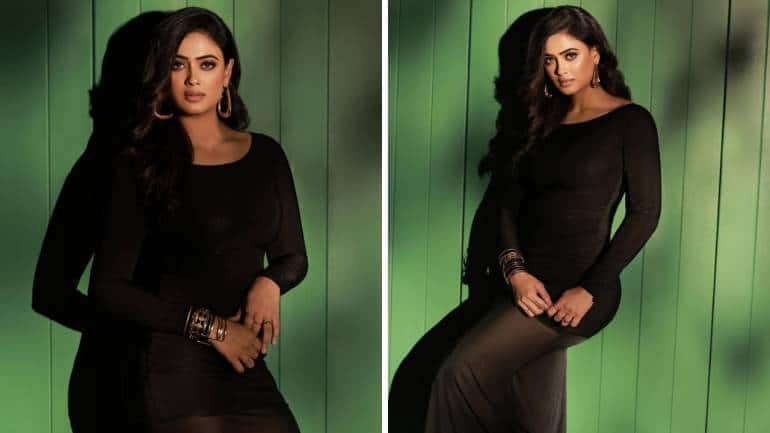 <strong>Sheer black beauty</strong><br />The actress seems to be ageing in reverse, as she looks younger than ever in this body-hugging black dress with sheer details. The bold number has been styled with contemporary gold earrings and a stack of bracelets.