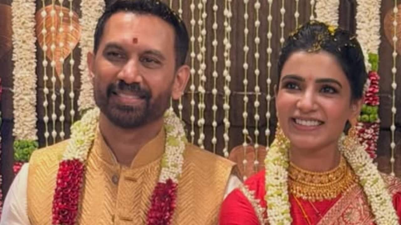 Samantha and Raj seated together - Samantha and Raj were married in an intimate ceremony at the Isha Foundation on December 1. The couple’s traditional attire and serene smiles set the tone for a quiet, heartfelt celebration.
