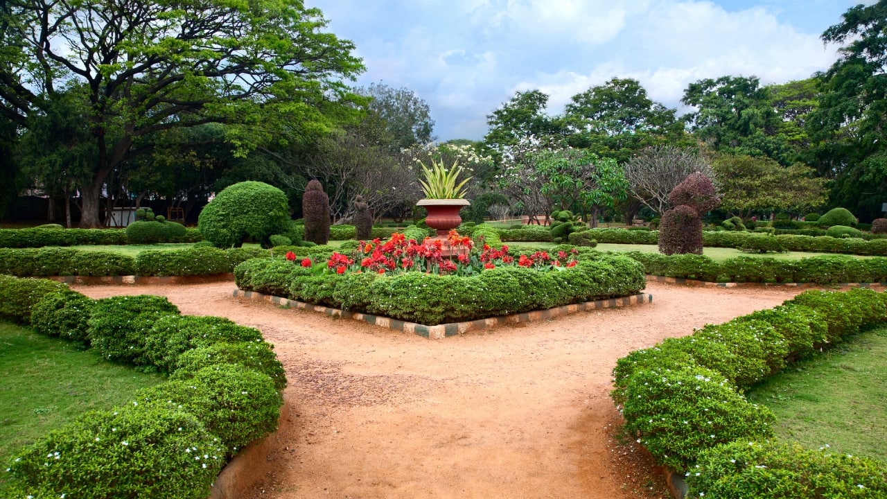 1. Lalbagh Botanical Garden, Karnataka, India — The World’s Most Searched Botanical Garden Lalbagh isn’t just a garden — it’s a breathing archive of India’s botanical history. Spread across 240 lush acres in Bengaluru, this 18th-century garden was first conceived by Hyder Ali and expanded by Tipu Sultan, who introduced exotic plant species from Persia, Africa, and France. Today, it houses more than 1,000 plant varieties, including some of the oldest recorded trees in South India. The garden’s iconic glasshouse, modelled after London’s Crystal Palace, hosts vibrant biannual flower shows that attract lakhs of visitors. Quiet lakes reflect canopies of age-old rain trees, lotus blooms add colour to still waters, and rocky outcrops offer sweeping panoramic views of the entire garden. It’s no wonder Lalbagh is the most searched garden on Google Maps — it’s a serene escape, a photographer’s dream, and a botanist’s paradise.1. Lalbagh Botanical Garden, Karnataka, India — The World’s Most Searched Botanical Garden Lalbagh isn’t just a garden — it’s a breathing archive of India’s botanical history. Spread across 240 lush acres in Bengaluru, this 18th-century garden was first conceived by Hyder Ali and expanded by Tipu Sultan, who introduced exotic plant species from Persia, Africa, and France. Today, it houses more than 1,000 plant varieties, including some of the oldest recorded trees in South India. The garden’s iconic glasshouse, modelled after London’s Crystal Palace, hosts vibrant biannual flower shows that attract lakhs of visitors. Quiet lakes reflect canopies of age-old rain trees, lotus blooms add colour to still waters, and rocky outcrops offer sweeping panoramic views of the entire garden. It’s no wonder Lalbagh is the most searched garden on Google Maps — it’s a serene escape, a photographer’s dream, and a botanist’s paradise. 1. Lalbagh Botanical Garden, Karnataka, India — The World’s Most Searched Botanical Garden Lalbagh isn’t just a garden — it’s a breathing archive of India’s botanical history. Spread across 240 lush acres in Bengaluru, this 18th-century garden was first conceived by Hyder Ali and expanded by Tipu Sultan, who introduced exotic plant species from Persia, Africa, and France. Today, it houses more than 1,000 plant varieties, including some of the oldest recorded trees in South India. The garden’s iconic glasshouse, modelled after London’s Crystal Palace, hosts vibrant biannual flower shows that attract lakhs of visitors. Quiet lakes reflect canopies of age-old rain trees, lotus blooms add colour to still waters, and rocky outcrops offer sweeping panoramic views of the entire garden. It’s no wonder Lalbagh is the most searched garden on Google Maps — it’s a serene escape, a photographer’s dream, and a botanist’s paradise.1. Lalbagh Botanical Garden, Karnataka, India — The World’s Most Searched Botanical Garden Lalbagh isn’t just a garden — it’s a breathing archive of India’s botanical history. Spread across 240 lush acres in Bengaluru, this 18th-century garden was first conceived by Hyder Ali and expanded by Tipu Sultan, who introduced exotic plant species from Persia, Africa, and France. Today, it houses more than 1,000 plant varieties, including some of the oldest recorded trees in South India. The garden’s iconic glasshouse, modelled after London’s Crystal Palace, hosts vibrant biannual flower shows that attract lakhs of visitors. Quiet lakes reflect canopies of age-old rain trees, lotus blooms add colour to still waters, and rocky outcrops offer sweeping panoramic views of the entire garden. It’s no wonder Lalbagh is the most searched garden on Google Maps — it’s a serene escape, a photographer’s dream, and a botanist’s paradise.