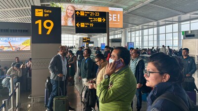 Passengers wait outside the Indira Gandhi International Airport in New Delhi, India, as several Indigo Airlines flights were either cancelled or delayed. (AP)