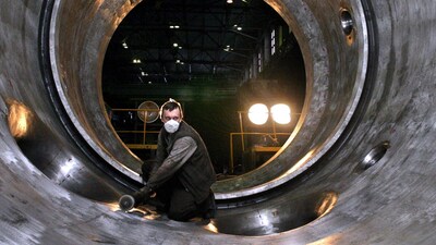 This file photo dating back to November 18, 2004, shows an employee of the Izhorsky engineering plant in St Petersburg polishing the interior of a 1,000-megawatt nuclear power reactor for Indian nuclear power plant in Kudankulam.