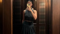<strong>Sporty yet chic</strong><br />Alia Bhatt also shared a mirror selfie wearing a sleek, dark-toned athleisure co-ord set. The ensemble features a fitted, sleeveless polo-style crop top with white trim on the collar and armholes, paired with a matching dark, pleated mini skirt.