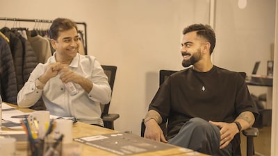 Abhishek Ganguly (L), co-founder and CEO of Agilitas talking to Virat Kohli