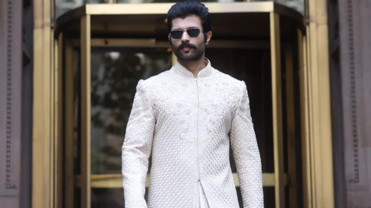 Ivory Sherwani This layered churidar bottom creates a rich, monochromatic texture that contrasts wonderfully with the sherwani's elaborate tone-on-tone embroidery. The sherwani jacket's full-length, structural design instantly adds height and a strong presence. The classic "Rowdy" move is to finish the ensemble with modern sunglasses and sandals, fusing tradition with a contemporary, unabashed edge.