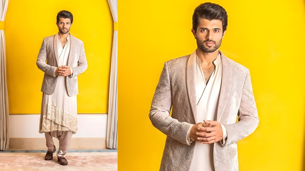The Deconstructed Drape and Blazer This is Deverakonda's most avant-garde work. An artistic, deconstructed drape is created by the asymmetrical, layered kurta/dhoti pants with a unique fringe design at the hem. It bridges the gap between a formal suit and traditional wear when worn with a blazer with a shawl collar and a blush or light tan texture. Elegant leather loafers serve as the look's foundation, making it a work of unorthodox elegance.