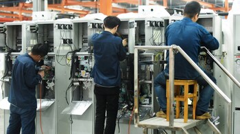 (FILES) Workers assemble power distribution cabinets at the State Grid Xiaoshan Electric Power Xinmei Electric Company in Hangzhou in eastern China's Zhejiang province on October 19, 2020. (Photo by AFP) 