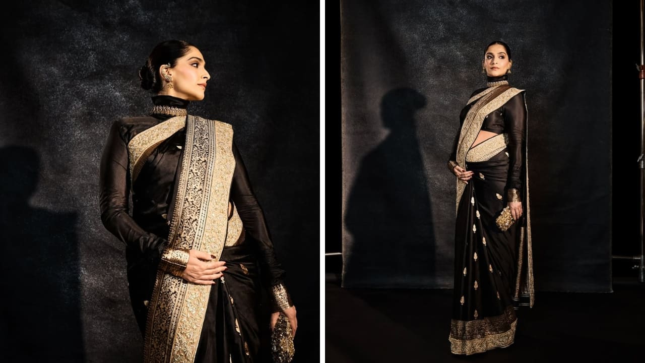 Classic Black Drape: There’s nothing like a classic black Banarasi drape. This one by Abu Jani and Sandeep Khosla features zari borders and unmatched craftsmanship. Her traditional drape is paired with a high-neck, long-sleeve blouse, making it look regal. Her accessories, makeup, and hair are flawless too. Classic Black Drape: There’s nothing like a classic black Banarasi drape. This one by Abu Jani and Sandeep Khosla features zari borders and unmatched craftsmanship. Her traditional drape is paired with a high-neck, long-sleeve blouse, making it look regal. Her accessories, makeup, and hair are flawless too.