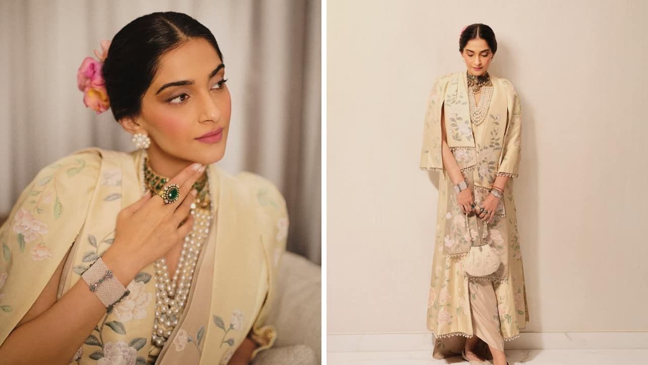 Florals and Pearls: She is a beauty in this charming floral ensemble by Tarun Tahiliani × de Gournay. The embroidered set brings vintage glamour with its styling. It’s accessorised with a statement choker and layers of pearl necklaces. There are also pearl earrings and a pearl potli bag that enhance the fit’s classic appeal. Florals and Pearls: She is a beauty in this charming floral ensemble by Tarun Tahiliani × de Gournay. The embroidered set brings vintage glamour with its styling. It’s accessorised with a statement choker and layers of pearl necklaces. There are also pearl earrings and a pearl potli bag that enhance the fit’s classic appeal.