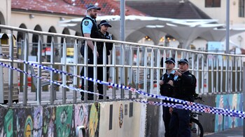 Police inspect at the scene of a shooting at Bondi Beach in Sydney on December 15, 2025. (Photo by DAVID GRAY / AFP)