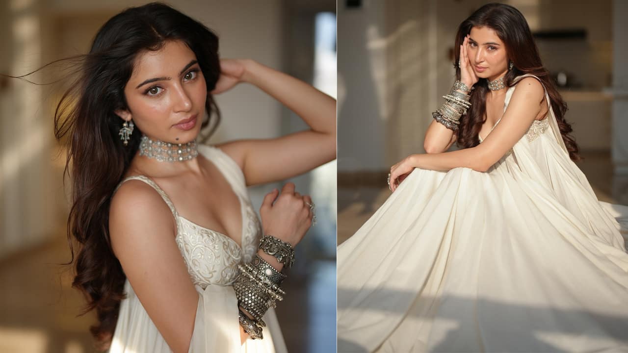 Traditional look The actress looks stunning in an off-white traditional voluminous anarkali gown. The bodice has delicate embroidery or detailing, with a deep V-neck and thin straps. She completed her look with the heavy, oxidised silver jewellery: a thick choker necklace, delicate drop earrings, and multiple sets of bangles stacked high on both arms.