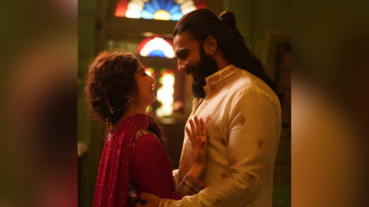 Vibrant red In this scene from Dhurandhar, Sara donned a deep red traditional outfit as she posed with Ranveer Singh. She is wearing a rich red dupatta draped over a traditional blouse. Her hair is styled in romantic curls, and she wears large, traditional earrings.