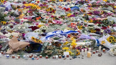 Flowers and candles placed near the site of the mass shooting at Bondi Beach in Sydney, Australia.