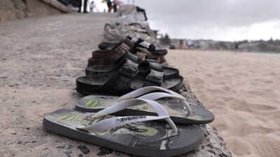 Belongings of members of the Jewish community are seen at the scene of a shooting at Bondi Beach in Sydney on December 15, 2025. (Photo by DAVID GRAY / AFP)