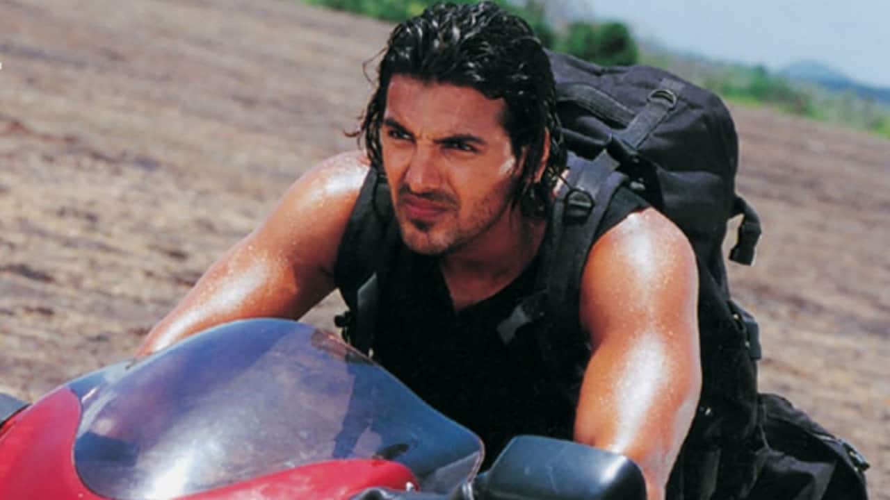 Dhoom Dhoom is the movie that made John Abraham the coolest villain in Bollywood. John portrayed Kabir, the head of a fashionable motorbike gang that commits high-tech thefts all around Mumbai, in this slick action movie. Abhishek Bachchan, who played ACP Jai Dixit, and Uday Chopra, who played the silly but endearing assistant Ali, stood opposite him. Their rivalry between cops and gangsters became famous. Fans still view Dhoom as one of his greatest performances and a pivotal moment in his career, even years after.