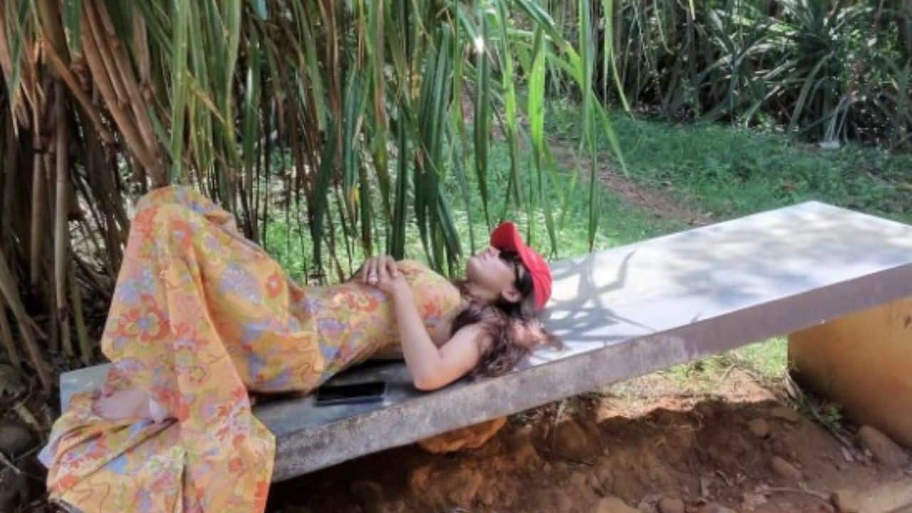 Laid-back nature escape Embracing slow travel, Rashmika is seen resting on a stone bench under dense greenery, dressed in a flowing floral outfit and a red cap. The candid frame reflects her love for unwinding in nature and soaking in peaceful moments away from the spotlight. Laid-back nature escape Embracing slow travel, Rashmika is seen resting on a stone bench under dense greenery, dressed in a flowing floral outfit and a red cap. The candid frame reflects her love for unwinding in nature and soaking in peaceful moments away from the spotlight.