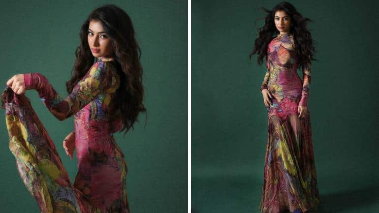 <strong>Vibrant in florals</strong><br />She is a beauty in this striking floral dress in lovely shades of pink and green. Her figure-flattering long dress features a closed neckline, long sleeves, a fitted bodice, and a flowing bottom. With dewy-fresh glam and curly hair, she looks refreshingly different.