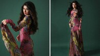 <strong>Vibrant in florals</strong><br />She is a beauty in this striking floral dress in lovely shades of pink and green. Her figure-flattering long dress features a closed neckline, long sleeves, a fitted bodice, and a flowing bottom. With dewy-fresh glam and curly hair, she looks refreshingly different.