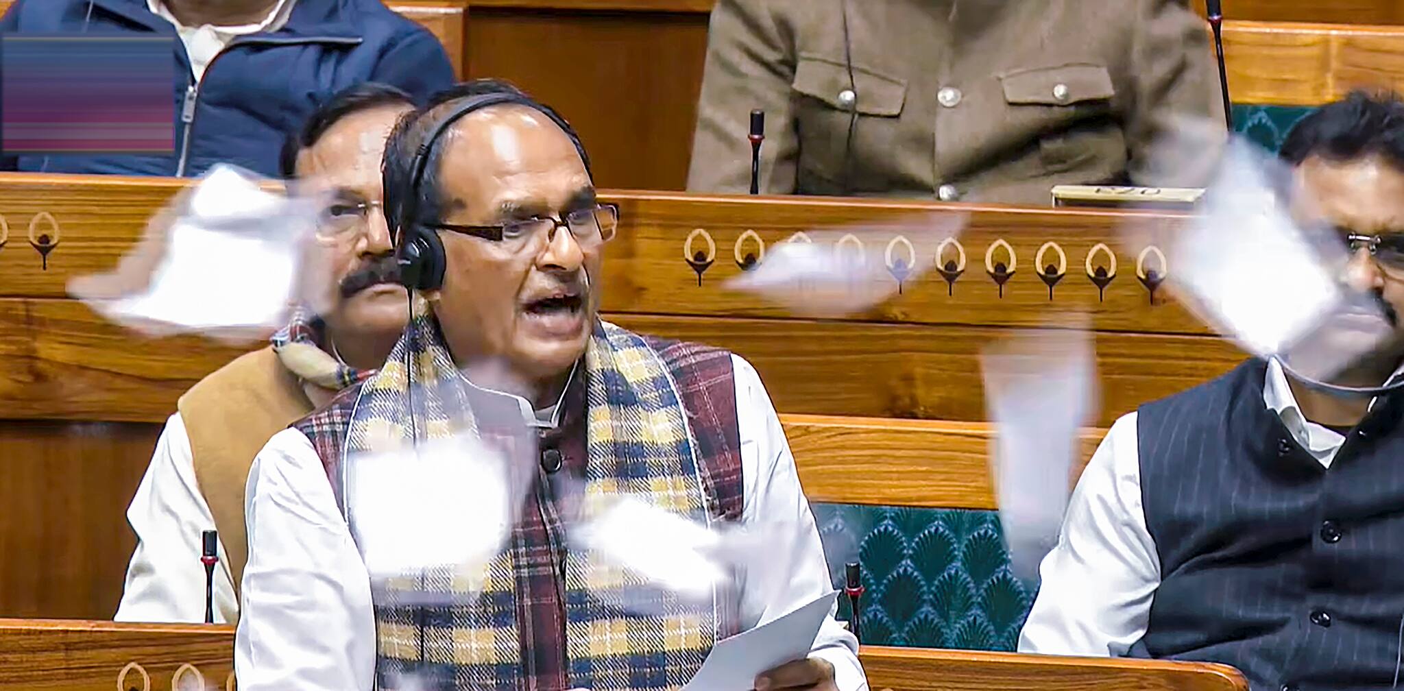 Union Minister Shivraj Singh Chouhan speaks in the Lok Sabha as opposition members throw papers in protest during the Winter session of Parliament. (PTI photo)