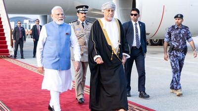 Prime Minister Narendra Modi (L) walks alongside Oman's Deputy Prime Minister for Defence Affairs Sayyid Shihab bin Tariq al-Said during a welcome ceremony upon his arrival in Muscat on December 17, 2025. (Photo by HAITHAM AL-SHUKAIRI / AFP)