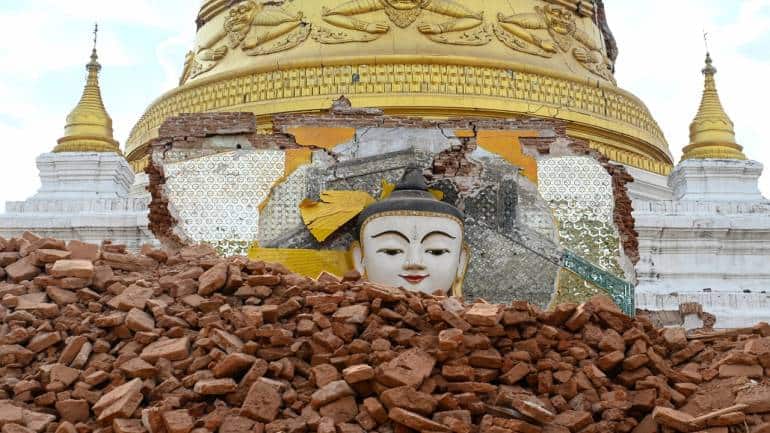 This photo taken on April 12 shows a damaged Buddha statue surrounded by debris at Lawkatharaphu Pagoda in Inwa on the outskirts of Mandalay, following the devastating March 28 earthquake. 