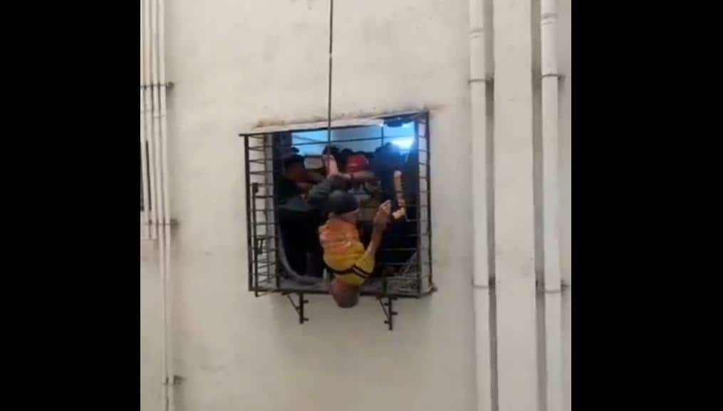 Watch: Man slips from 10th floor window, dangles from 8th-floor grille before dramatic rescue
