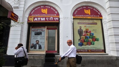 People walk past Punjab National Bank's Brady House branch in Mumbai