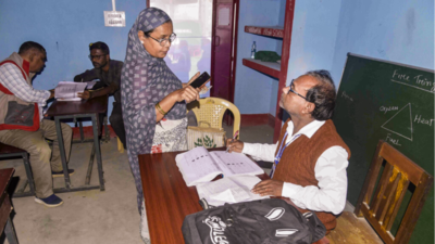 A booth level officer (BLO) interacts with a voter during verification of voter identification cards as part of 'Special Revision' (SR) of electoral rolls of Assam, in Guwahati