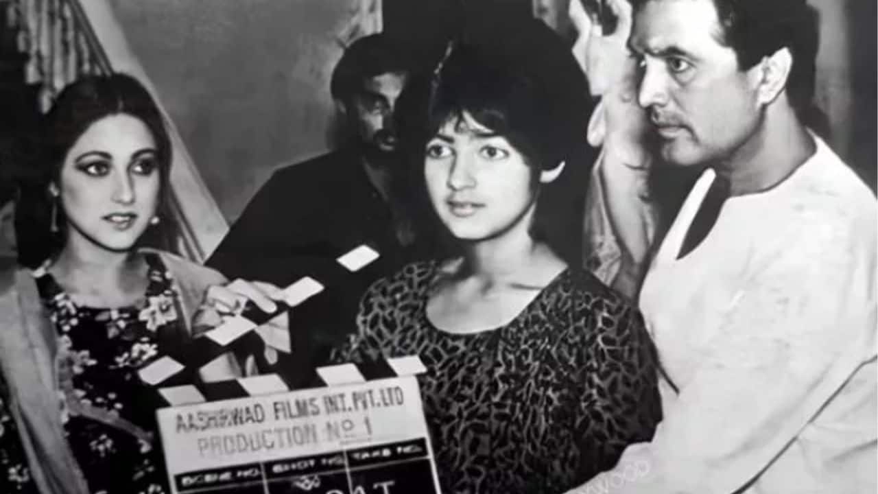 The monochromatic picture captures a rare glimpse from the filming of Rajesh Khanna's Alag Alag, showing the superstar beside his young daughter Twinkle Khanna during the film’s muhurat.  Twinkle is seen holding the clapperboard with both father and daughter look away, caught in a candid moment before the first shot. Tina Ambani, the film's leading lady, can be seen in the background, enhancing the frames timeless appeal.