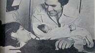 The black-and-white photograph shared by Twinkle Khanna herself on Instagram, captures an intimate, life-changing moment as Rajesh Khanna cradles newborn Twinkle Khanna in his arms, smiling with unmistakable pride. Dimple Kapadia, resting beside him, looks up tenderly, the quiet exhaustion of childbirth softened by warmth and love.