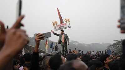 A cutout of Bangladesh Nationalist Party (BNP) acting chairman Tarique Rahman is held as BNP supporters wait for Rahman's arrival to pay tribute to his father and former President Ziaur Rahman in Dhaka, Bangladesh, December 26, 2025. REUTERS/Anik Rahman