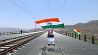 PM Modi waves the national flag as he visits the Chenab bridge, in Jammu and Kashmir. (Image: narendramodi.in)