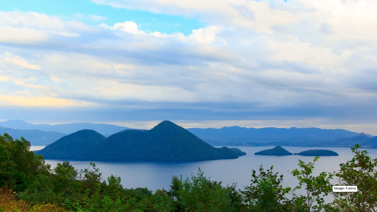 7. Lake Toya Lake Toya sits calmly within a volcanic caldera, surrounded by forested hills and distant peaks. The atmosphere here is slow and soothing—perfect for travellers looking to unwind. The nearby hot spring towns offer lakeside onsens, and during summer, fireworks light up the night sky almost daily, reflecting beautifully on the water. Stay suggestion: A lakeside ryokan for private onsen views. 7. Lake Toya Lake Toya sits calmly within a volcanic caldera, surrounded by forested hills and distant peaks. The atmosphere here is slow and soothing—perfect for travellers looking to unwind. The nearby hot spring towns offer lakeside onsens, and during summer, fireworks light up the night sky almost daily, reflecting beautifully on the water. Stay suggestion: A lakeside ryokan for private onsen views.