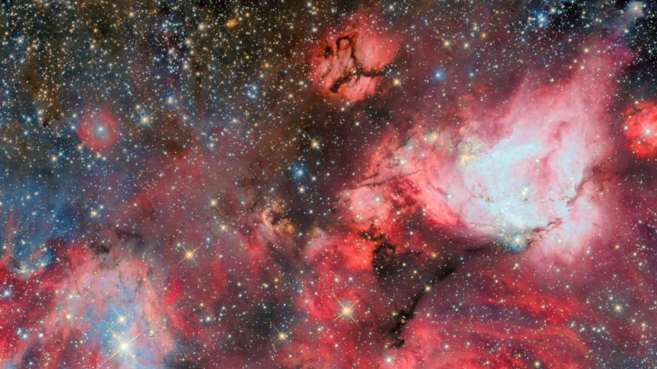 Hubble spots baby stars carving giant bubbles inside a distant cosmic cloud