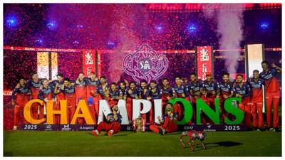 Royal Challengers Bengaluru (RCB) players posing with the championship trophy during the presentation ceremony of the IPL 2025 finals in Ahmedabad. (Courtesy: PTI photo)