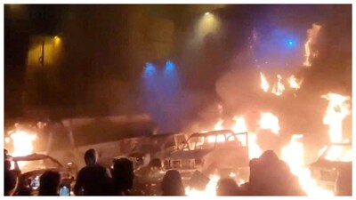 Protesters gather as vehicles burn, amid evolving anti-government unrest, in Tehran. (Courtesy: Reuters photo)