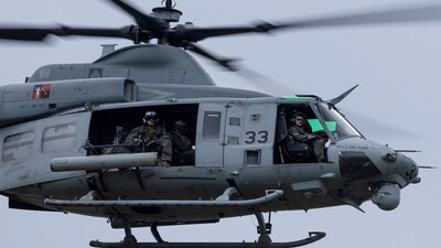 A U.S. Marine Corps UH-1Y Venom helicopter flies over during touch-and-go 
