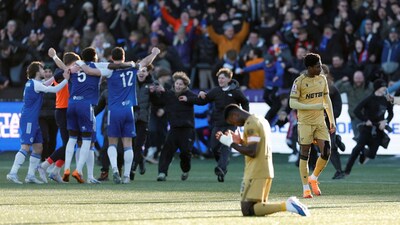 Crystal Palace's Marc Guehi looks dejected as Macclesfield F.C. players celebrate after the match Action Images. Reuters