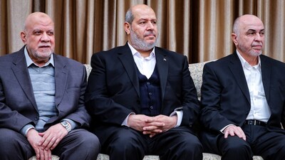 (FILES) This handout picture released by the office of Iran's Supreme Leader Ayatollah Ali Khamenei on February 8, 2025, shows (L to R) member of the Hamas political bureau Nizar Awadallah, deputy chairman of the Hamas political bureau Khalil al-Hayya and the head of the political council of Hamas Mohammad Ismail Darwish, meeting with him in Tehran. (Photo by KHAMENEI.IR / AFP)