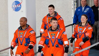 The crew of Artemis II, NASA's next-generation moon rocket, depart their quarters to take part in a countdown demonstration test atop the Space Launch System (SLS) rocket with the Orion crew capsule at the Kennedy Space Center in Cape Canaveral, Florida, U.S. December 20, 2025. Launch around the moon and back is scheduled for February 5, 2026. REUTERS/Joe Skipper